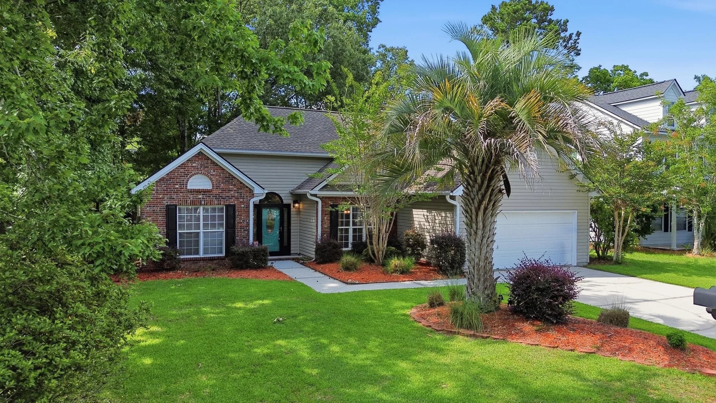 Front of the home framed by palms